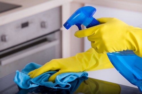 Cleaner preparing a kitchen and bathroom in an Ilford property