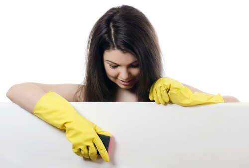Technician cleaning carpet in a busy Ilford home or flat